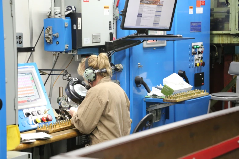 a man working on the machine and some electrical equipment