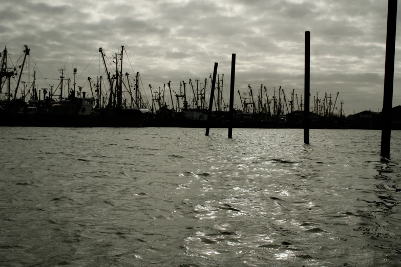 a very large body of water with some poles sticking out