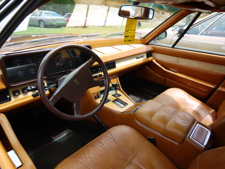 dashboard view of a classic car on display in an outside area