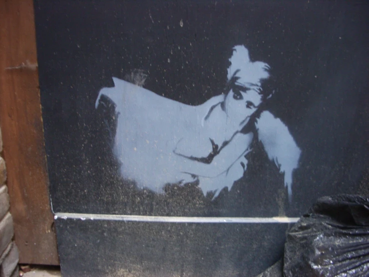 graffiti on the outside of a building with a boy in white