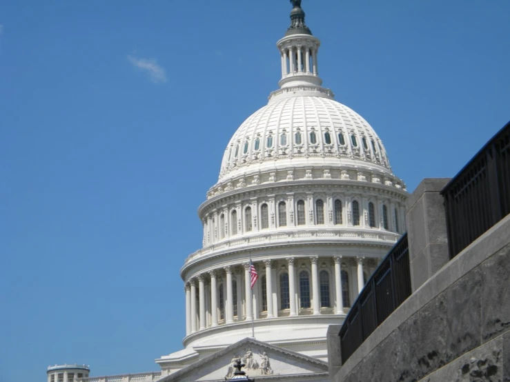 the dome of the capitol building has a american flag flying on it