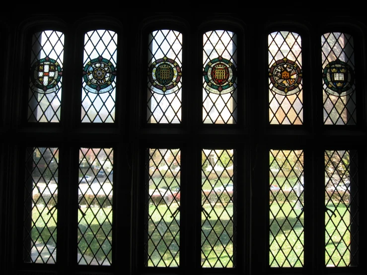 the three large stained glass windows are behind the curtain