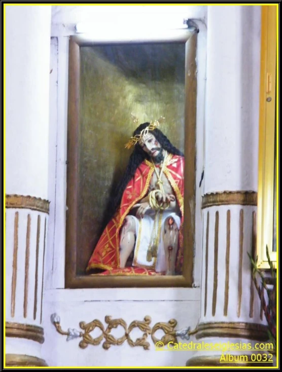 the statue is in the church, surrounded by pillars