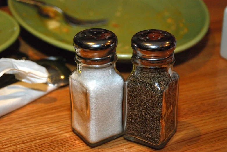 a couple of bottles filled with glitter on top of a wooden table