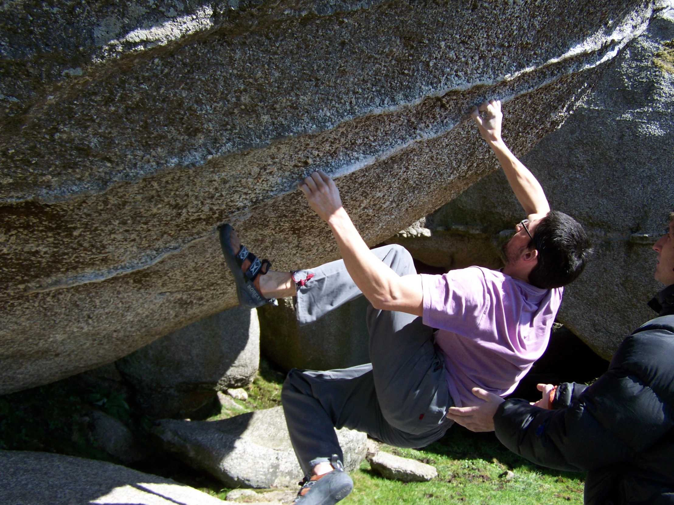 a man is attempting to climb up a cliff