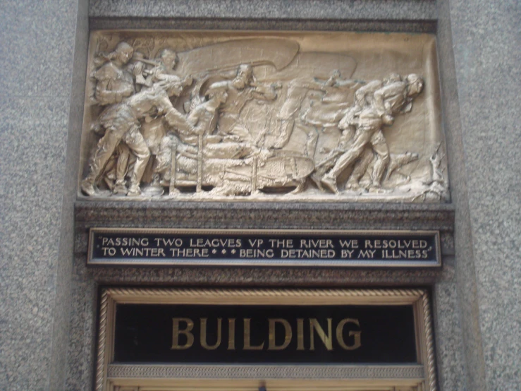 a statue of soldiers and a building sign