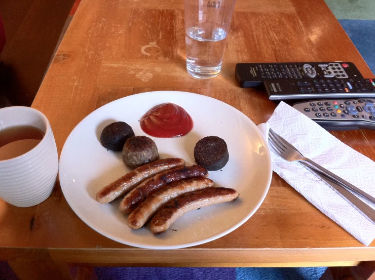 a plate of food with two sausages on it