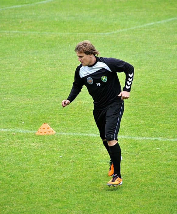 the soccer player has long hair on his head