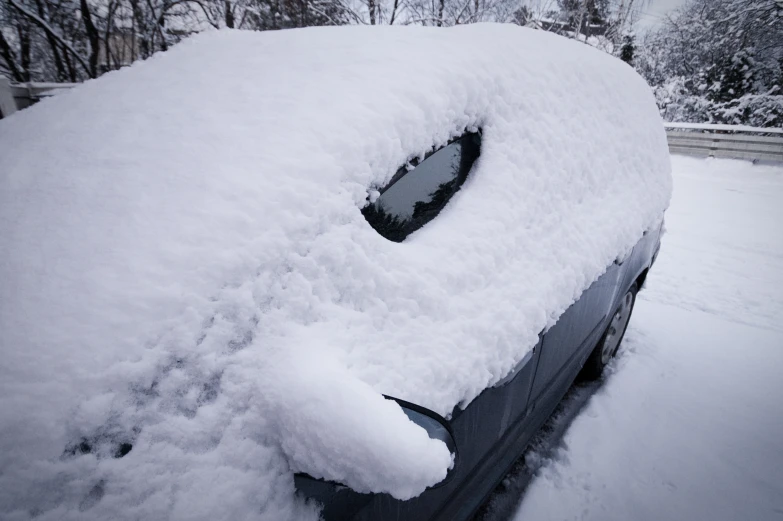 a car that is covered in snow during winter