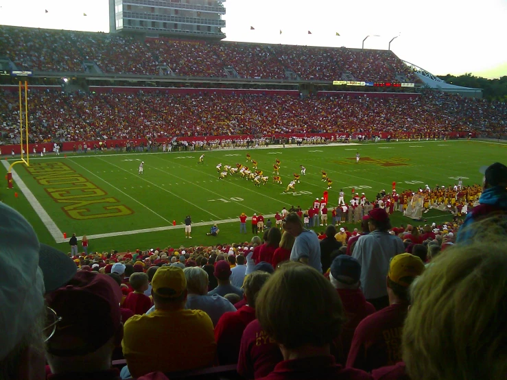 a crowd of people watching a football game