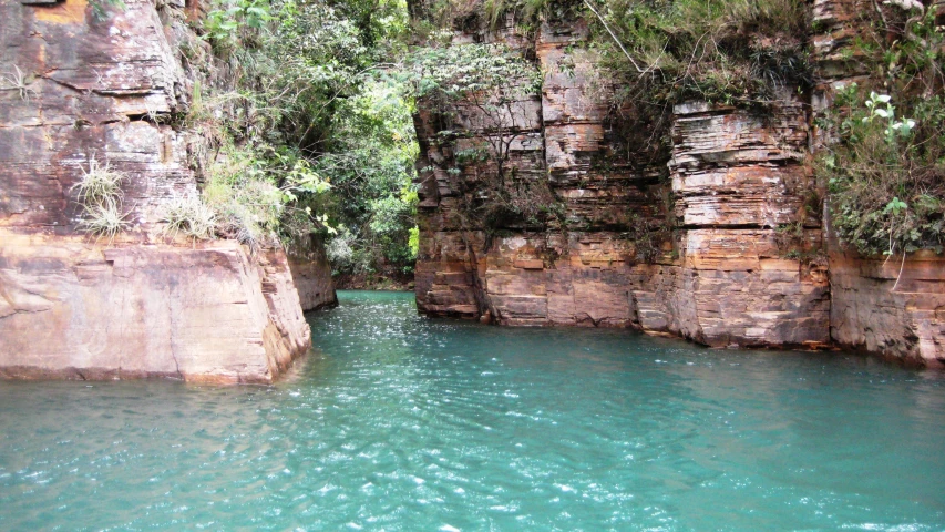 a view of a narrow river with some cliff side on either side
