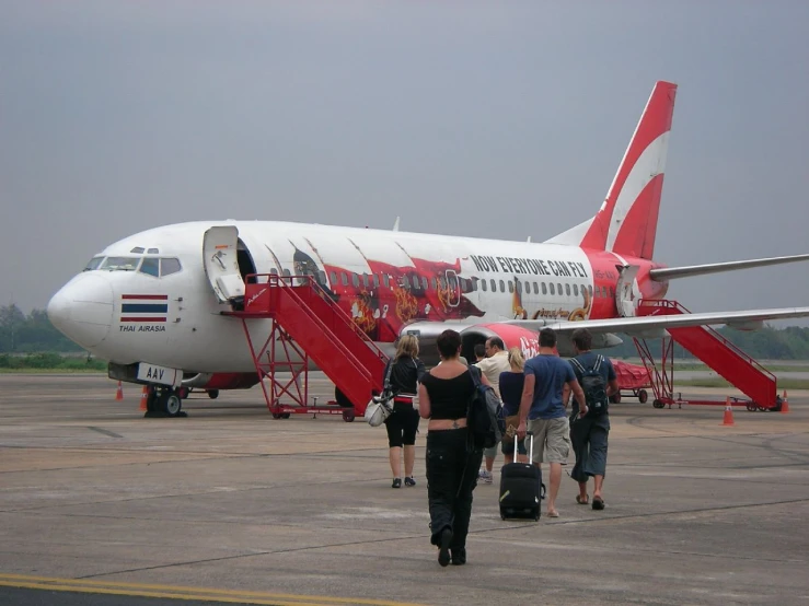 a large red and white airplane is on the runway