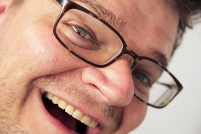 a close up image of a man with glasses