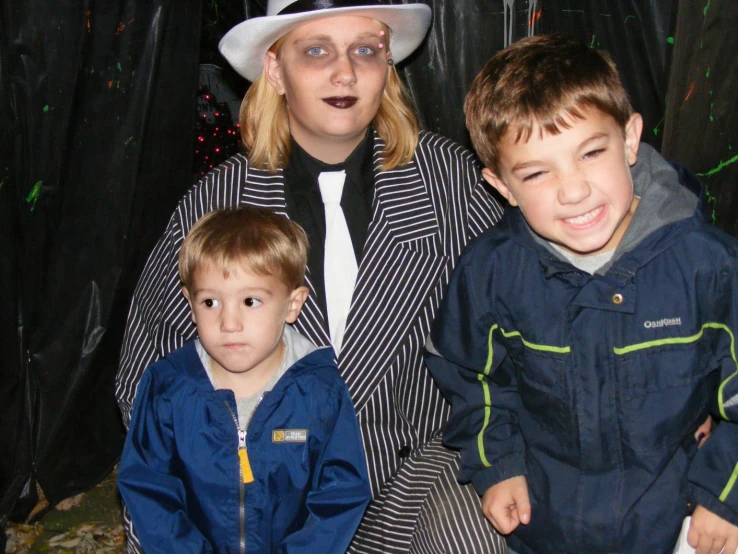 woman and children posing for pograph in front of christmas tree