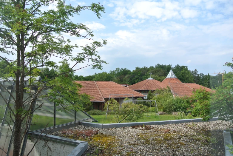 a red tiled house with its roof and window tins are seen from the top