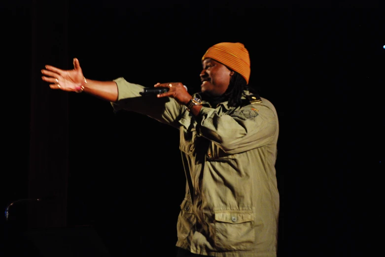 a man holding his hand out to someone on stage