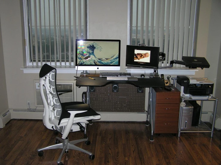 a desk with a computer and a tv