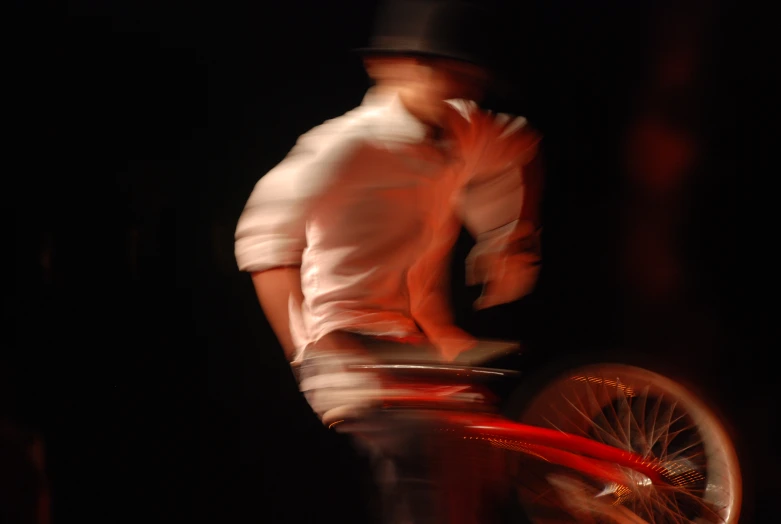 an blurry image of a man riding a bike