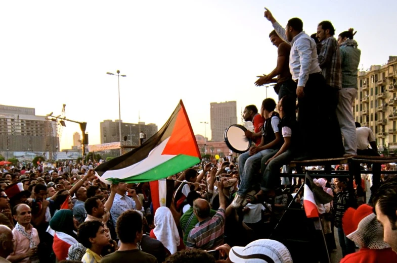 a crowd is watching people perform with instruments in the air