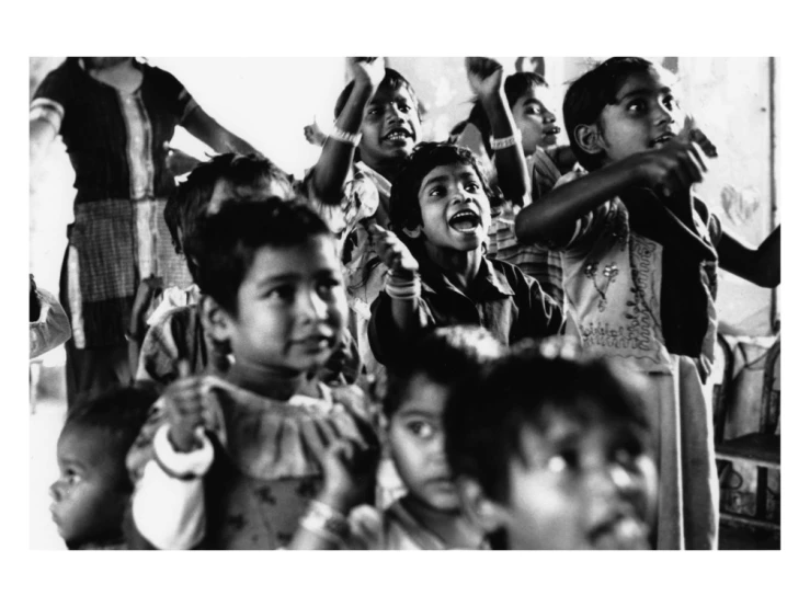 a group of children singing in front of their friends