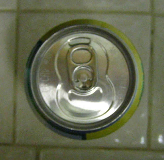 a can of beer is hanging on a wall