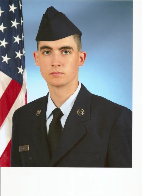 a po of a man in uniform, against an american flag