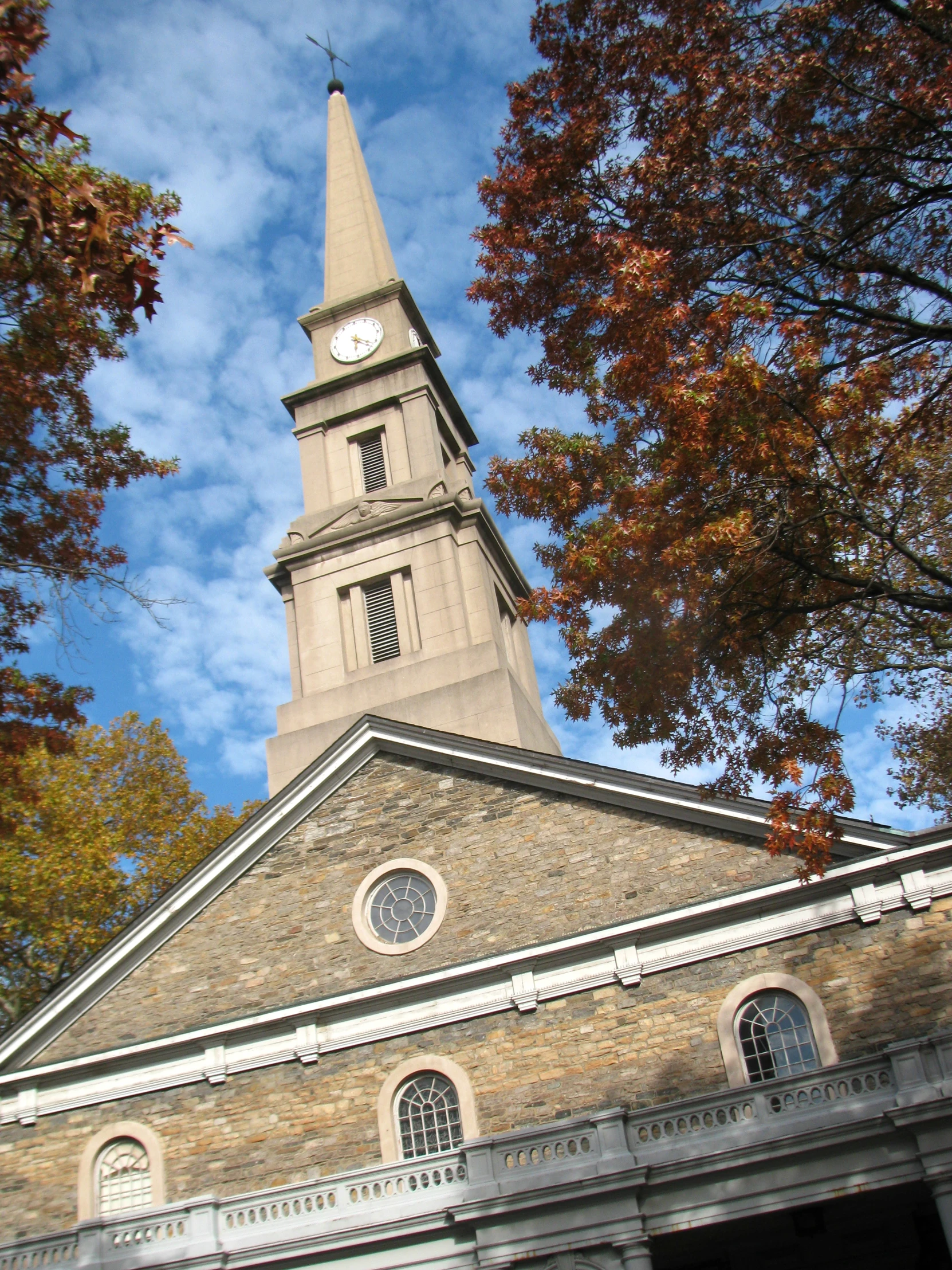 an old church building with a steeple and clock on it