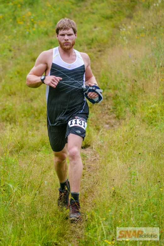 a man runs through some tall grass