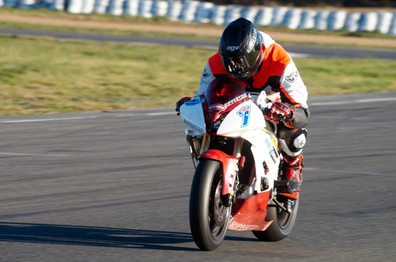 a person riding a motorcycle on a race track