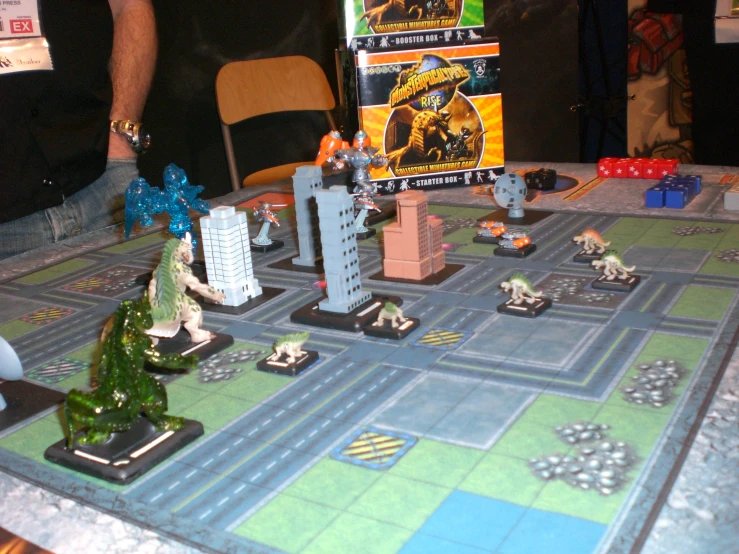 a close up of a board game with people standing in the background