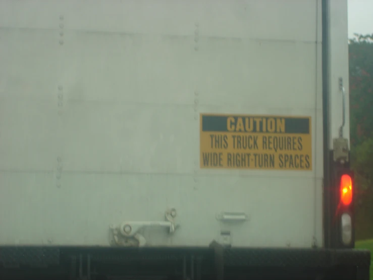 this is a picture of a back side of a truck with a warning