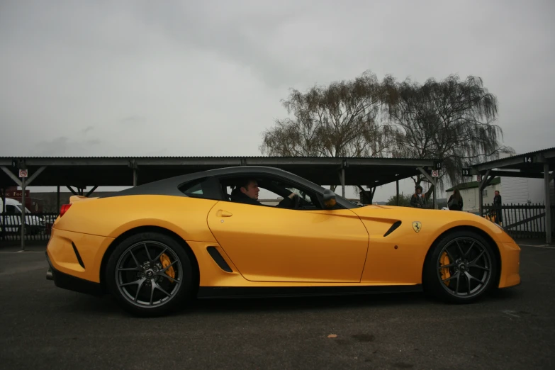 the yellow sports car is parked on the street