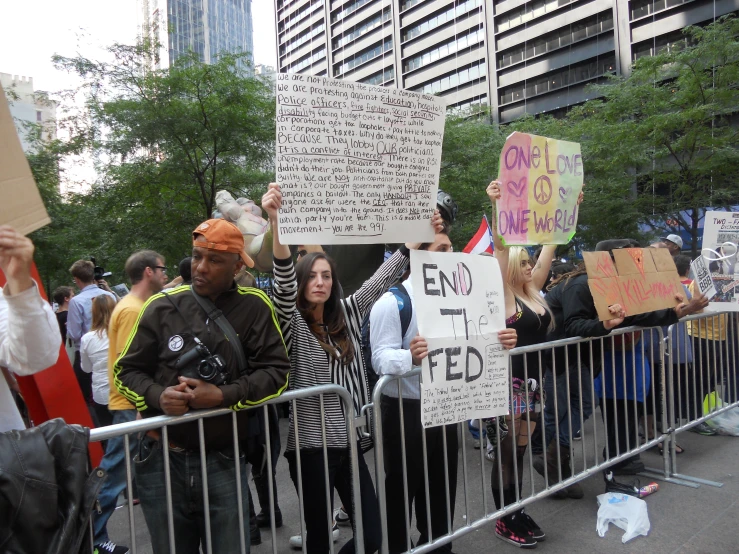 several people holding signs at a protest in a city