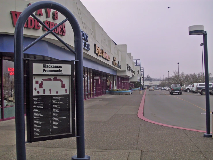 an empty road in a shopping district with no cars on it