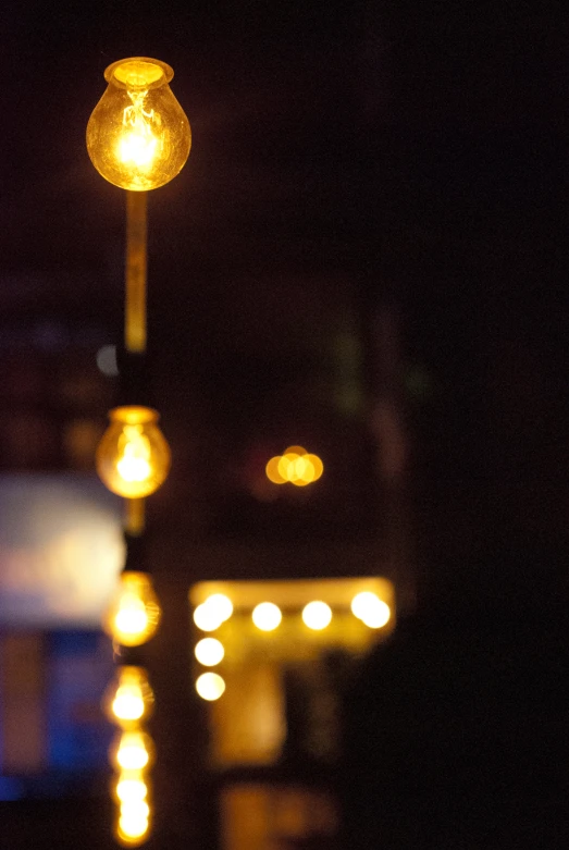 a street light shines brightly at night in the dark