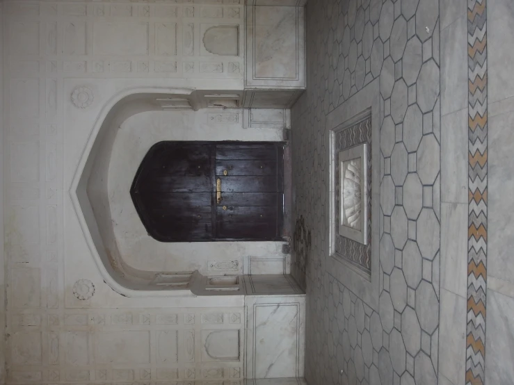 a large open entryway with decorative tiles around