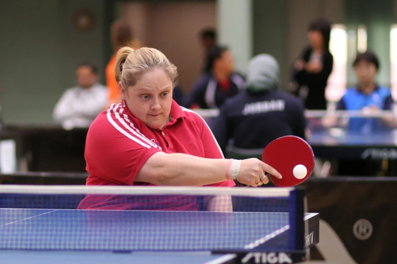 a female tennis player is about to hit the ball