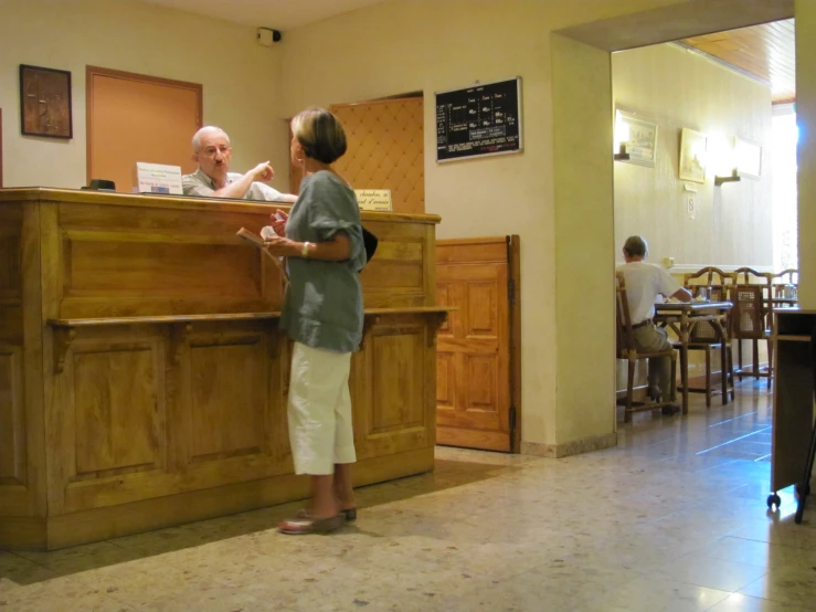 a man and woman sitting at a desk in a el lobby