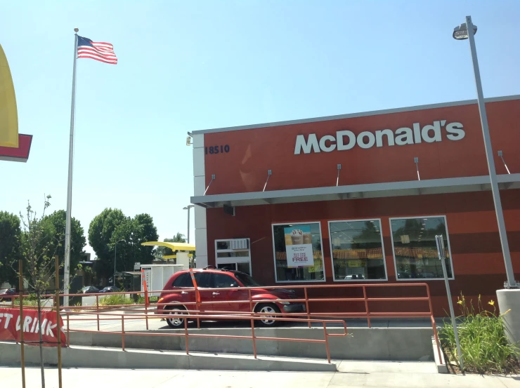 a mcdonald's restaurant with a red pickup parked outside