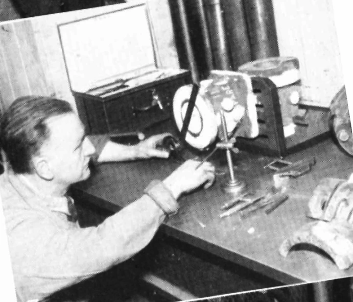 woman working at a desk in front of clock