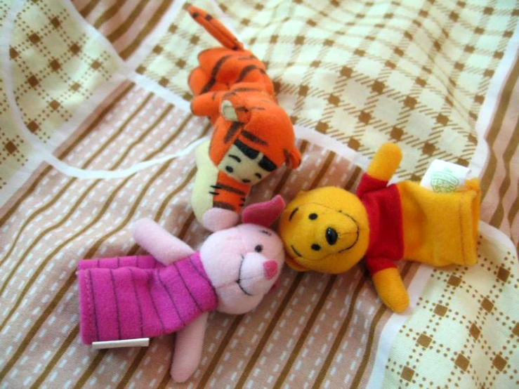 three colorful animal toys are shown next to each other