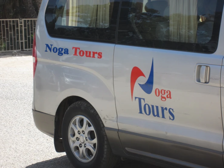 a van with yoga tours sticker parked outside