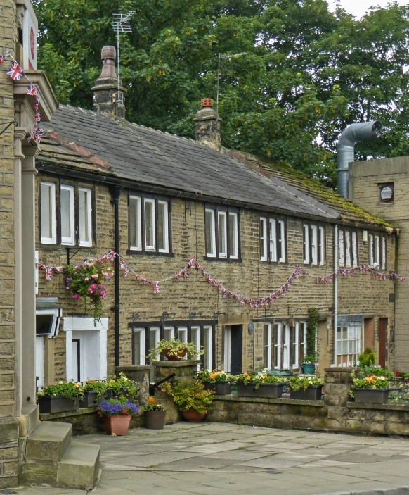 the building is brick with flower boxes in front of it