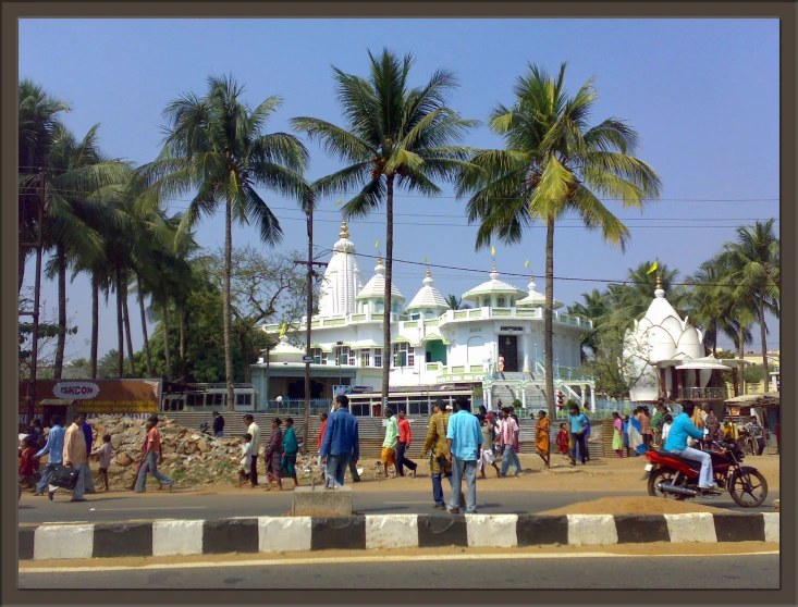 the crowds are gathered outside a temple near the beach