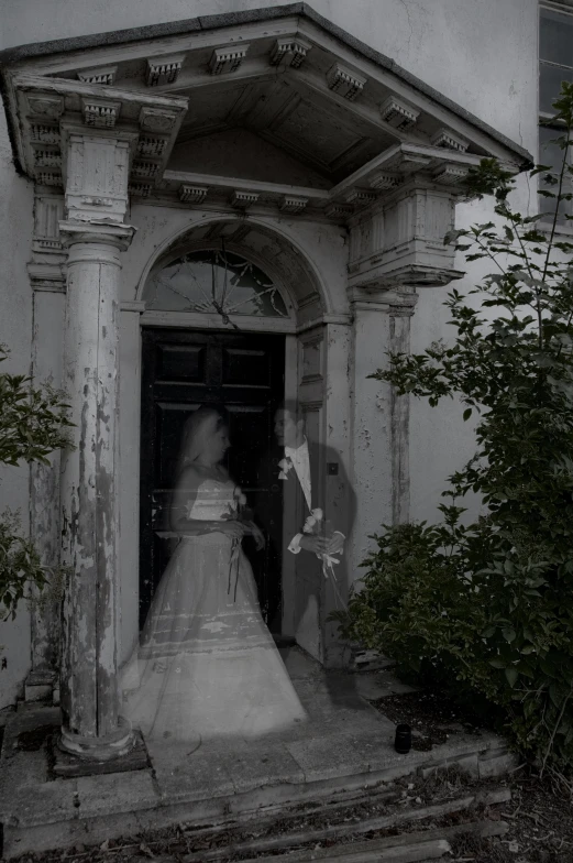 an old po of a man and woman walking towards a door