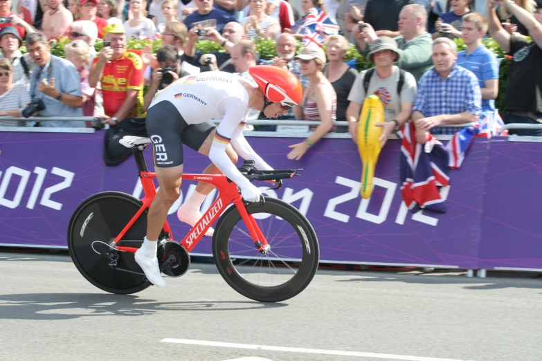 a person riding on the back of a red bike