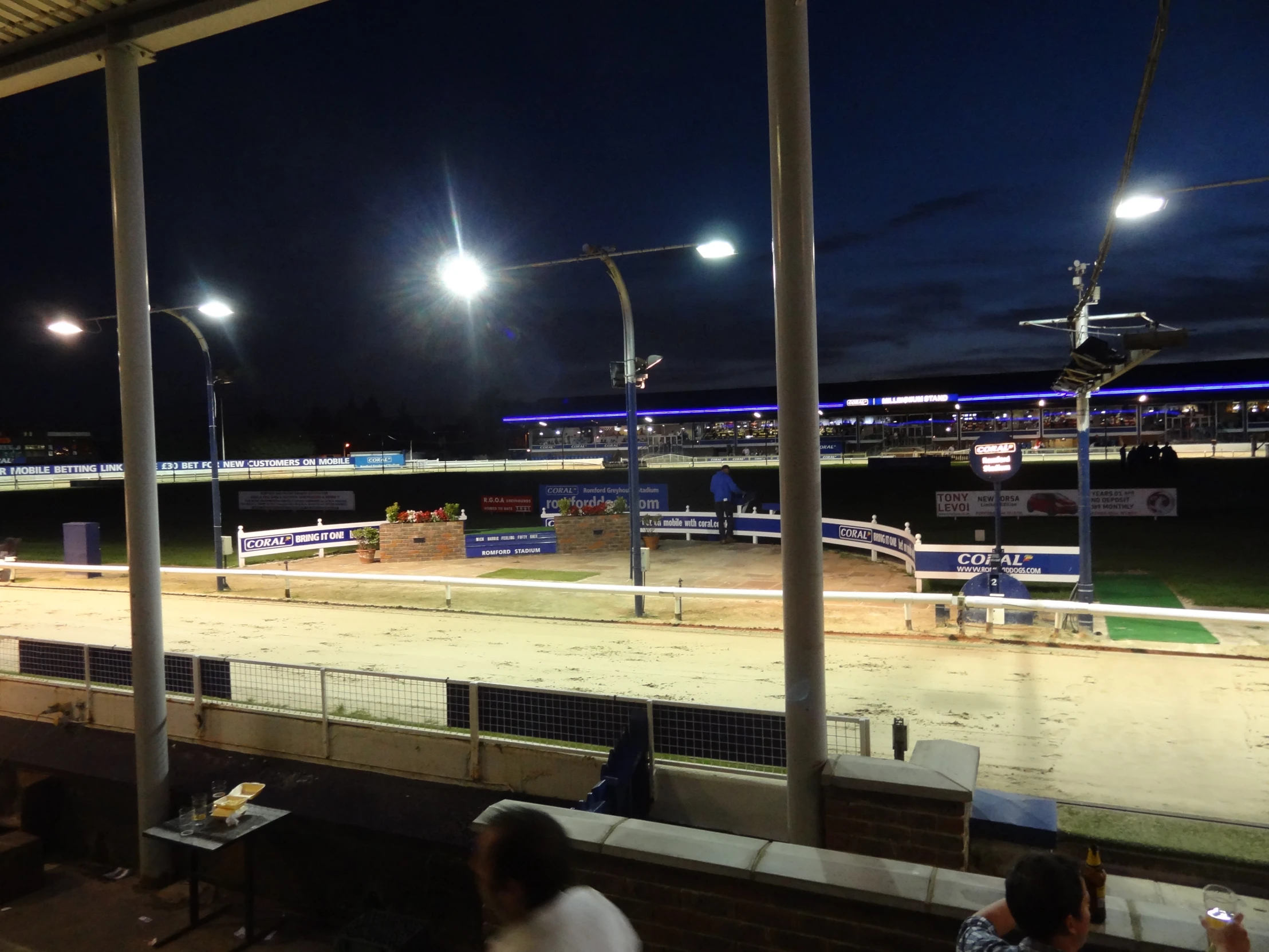 there are people sitting at the table at this empty race track