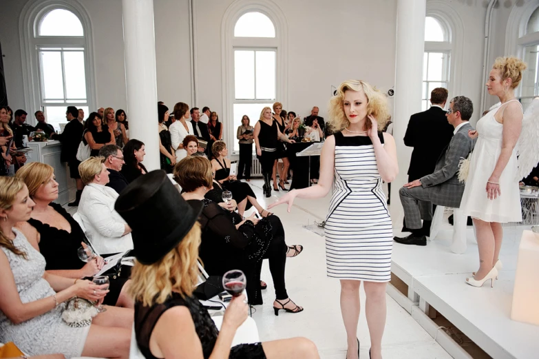 a runway showing a fashion show with people watching