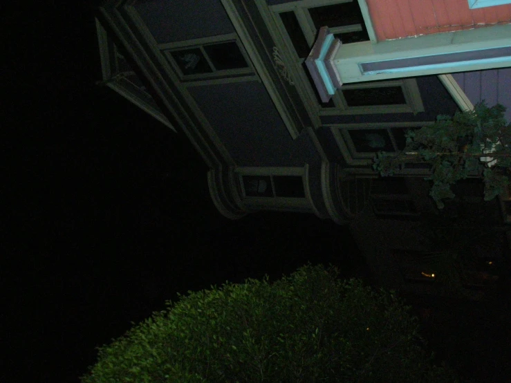 a street sign attached to a roof at night