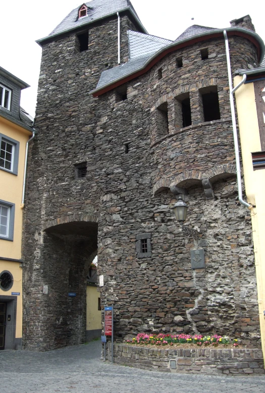 a couple of people are walking on a cobblestone street